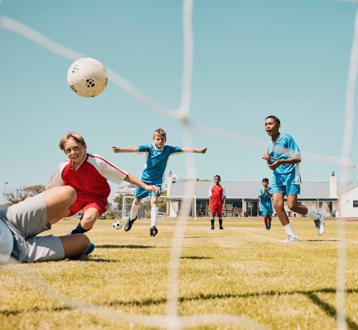 Soccer, children and sports with a boy team playing a game on a grass pitch or field for competitio.